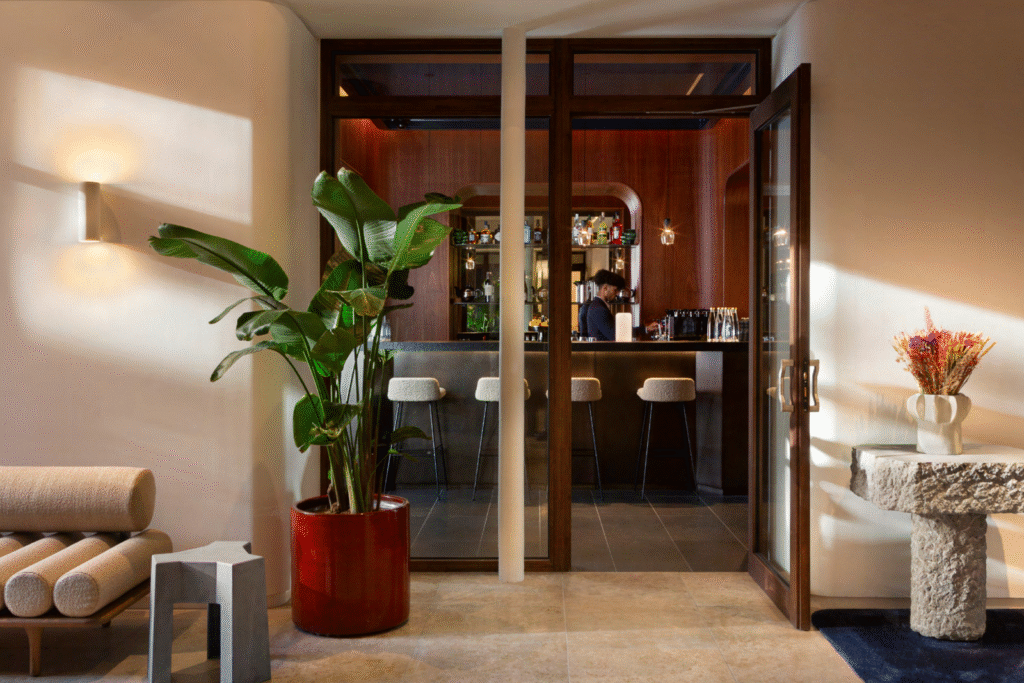 Hall d’accueil d’un immeuble haussmannien rue de la Paix à Paris, bar en tôle métallisée, réaménagement bureaux haut de gamme.